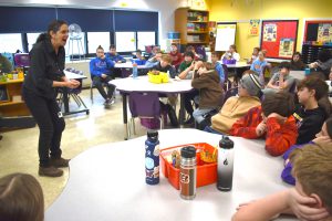 a woman teaches a classroom full of students