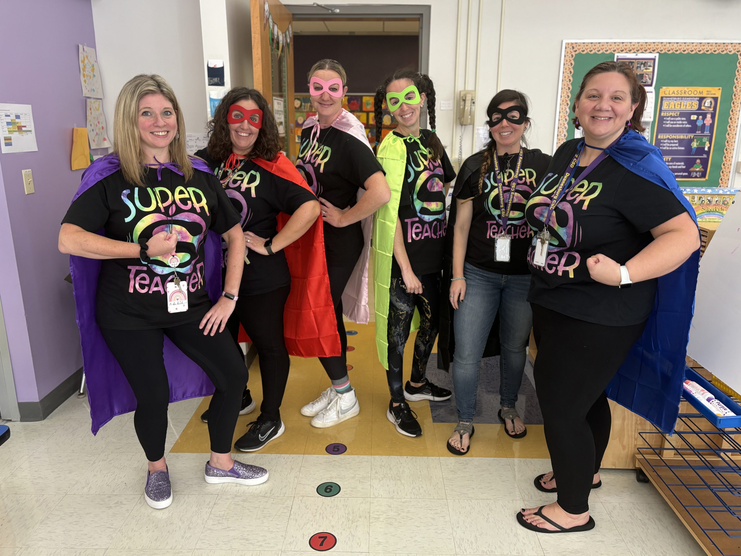 a group of teachers dressed up as superheroes for Halloween