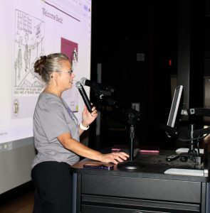 a woman speaks into a microphone