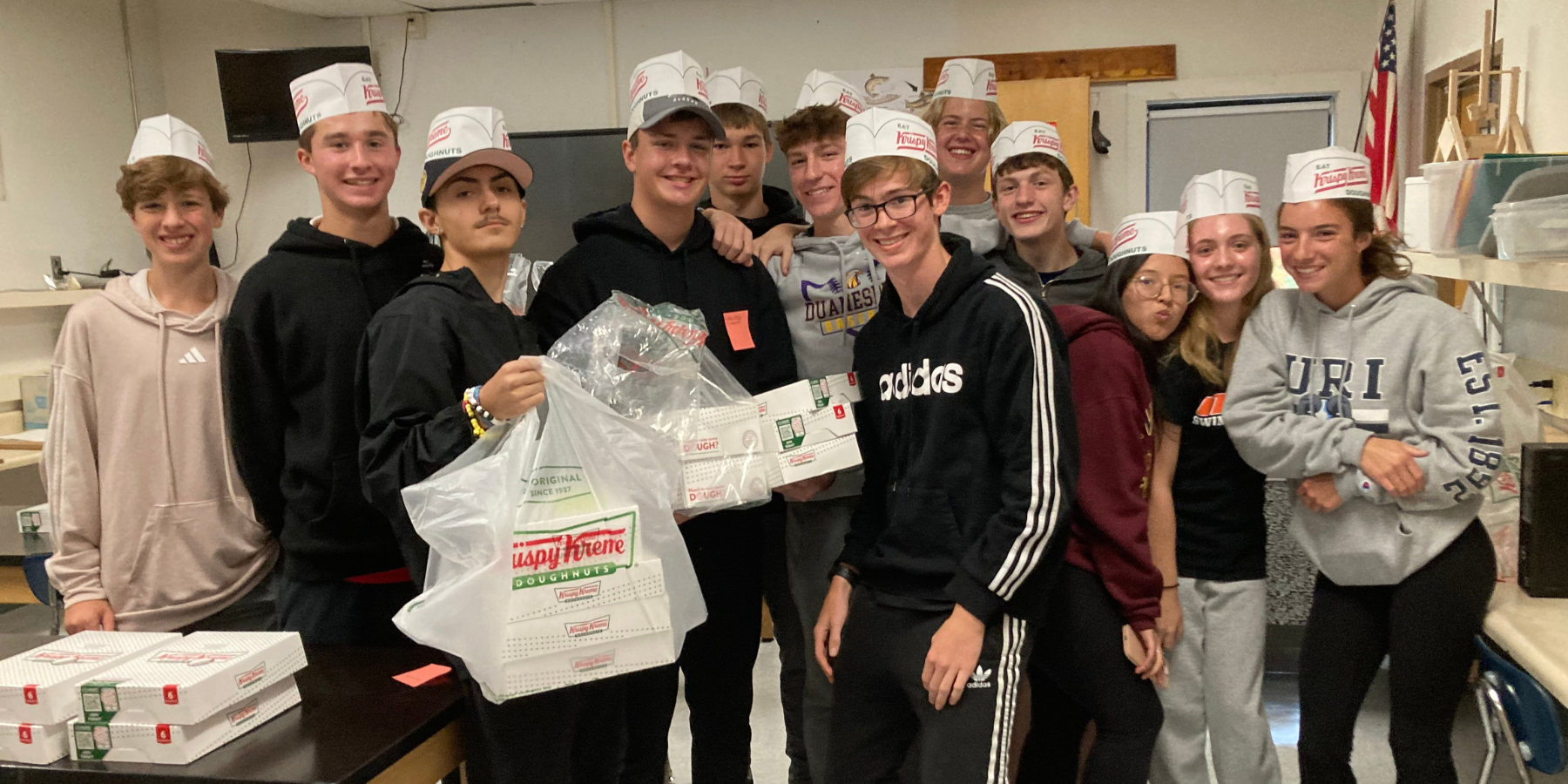 high school students pose with krispy kreme donuts