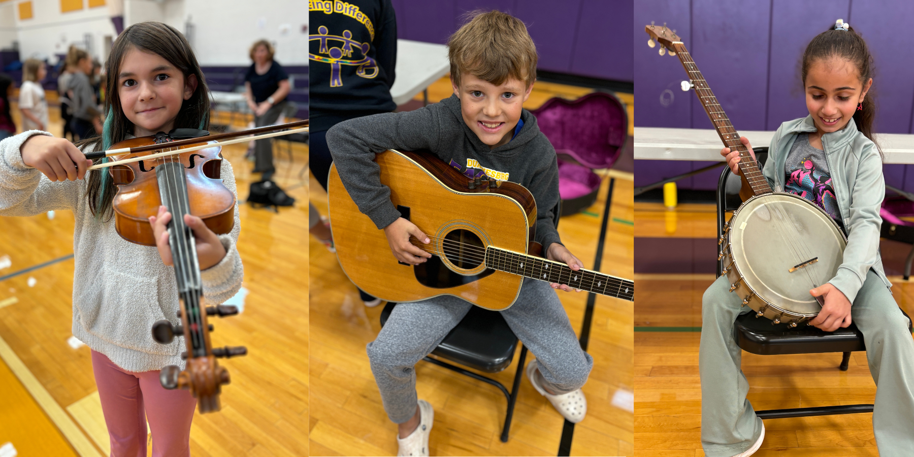 three young elementary students hold stringed instruments